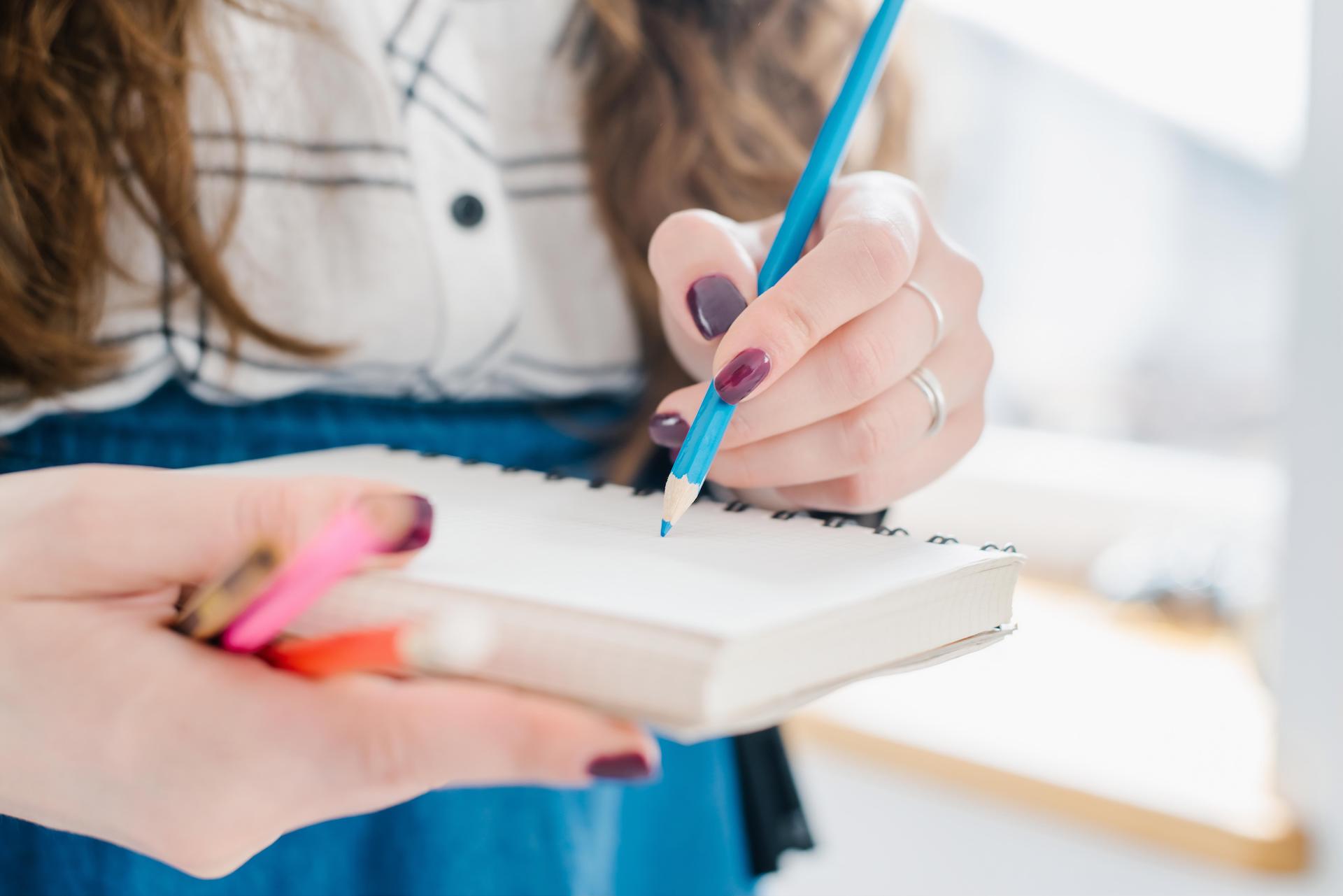 a woman takes notes in a notebook